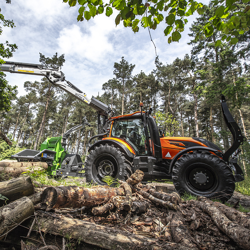 valtra t series in forest working candy orange colour